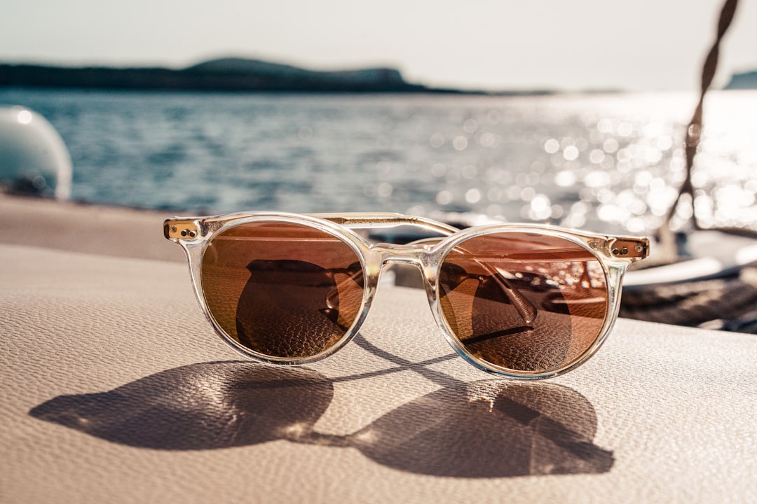 Stylish sunglasses under sunny sky, highlighting UV protection benefits
