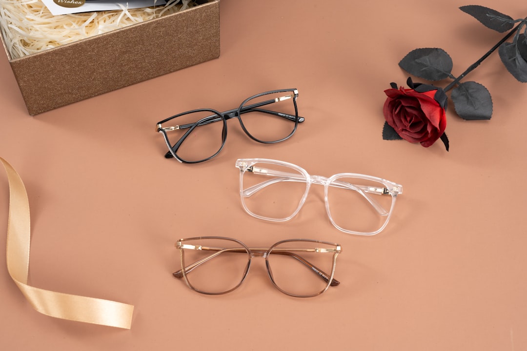 A person holding three stylish glasses frames at Fantastic Glasses in Okotoks.